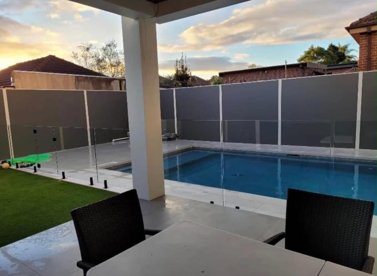 Rendered modular boundary wall installed beside a pool in Western Sydney